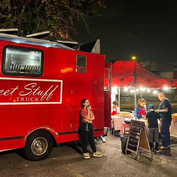 Sweet Stuff Truck, a red food truck, and a red tent serving customers at night.
